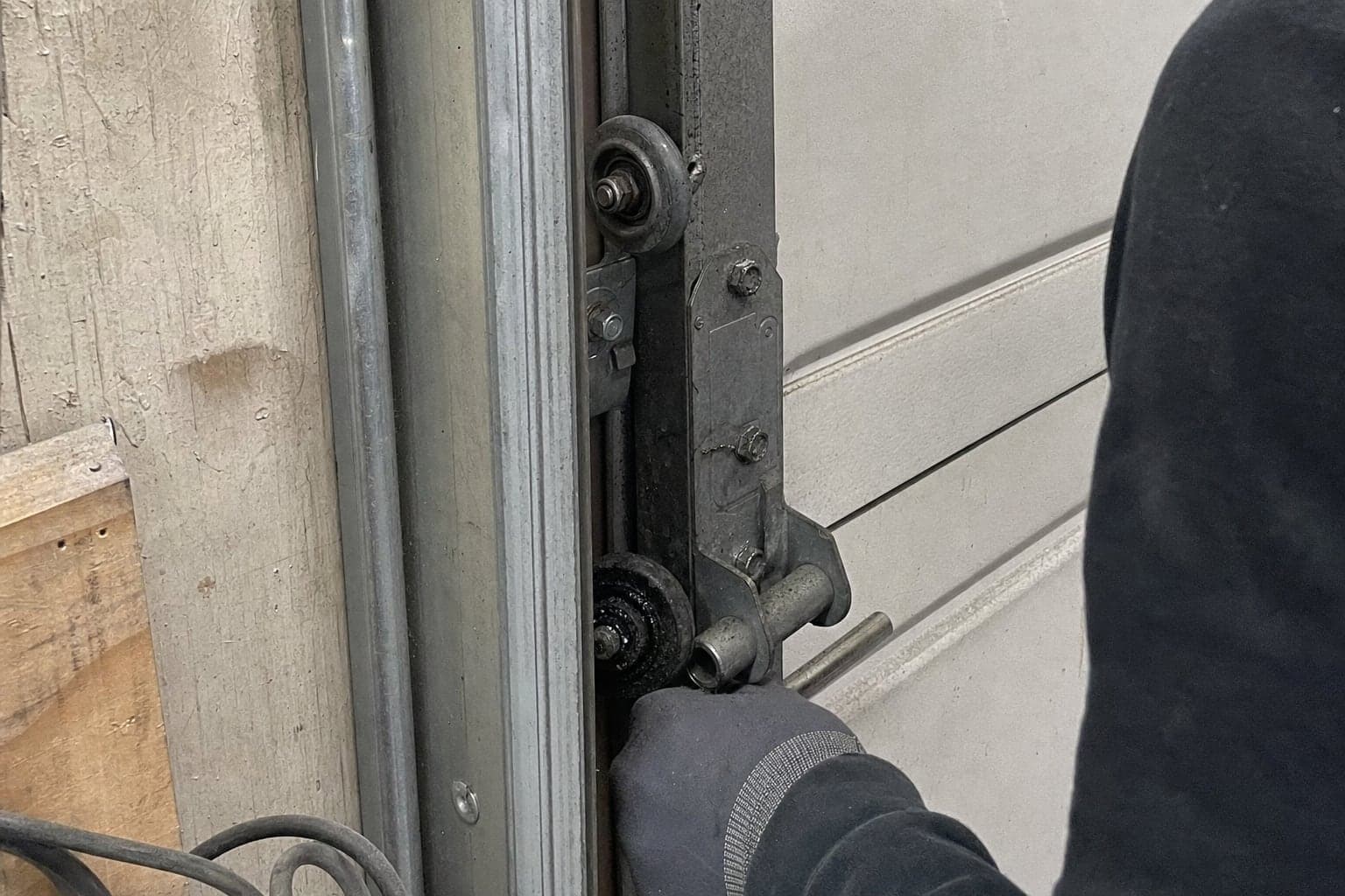 Worn rollers and a hinge on a commercial door track