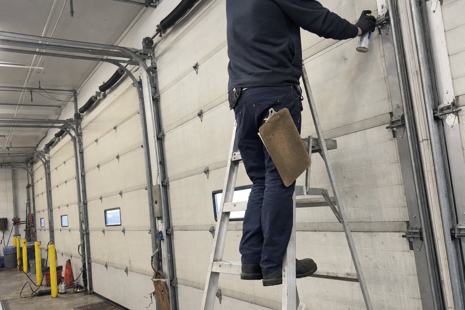 Lubricating the hinges and rollers of a warehouse door