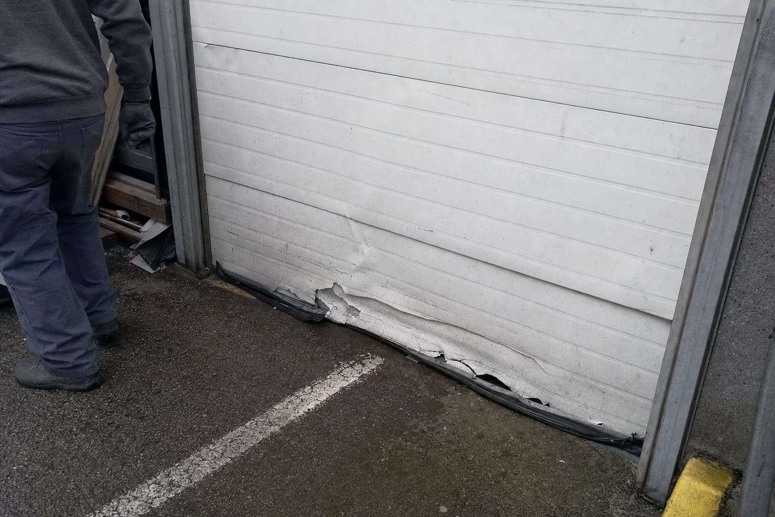 Dented bottom section of a shop overhead door