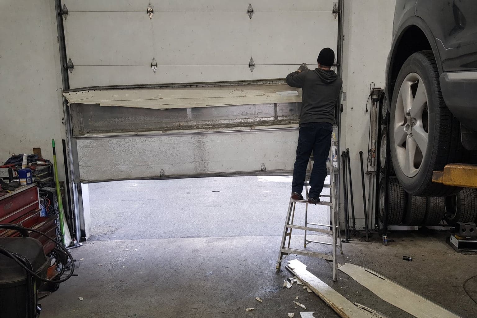 Replacing a damaged section on a service bay door