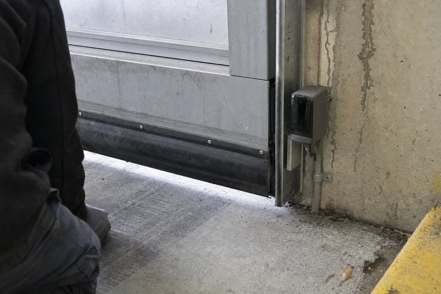 Photo eye and safety edge at the bottom of a parkade door
