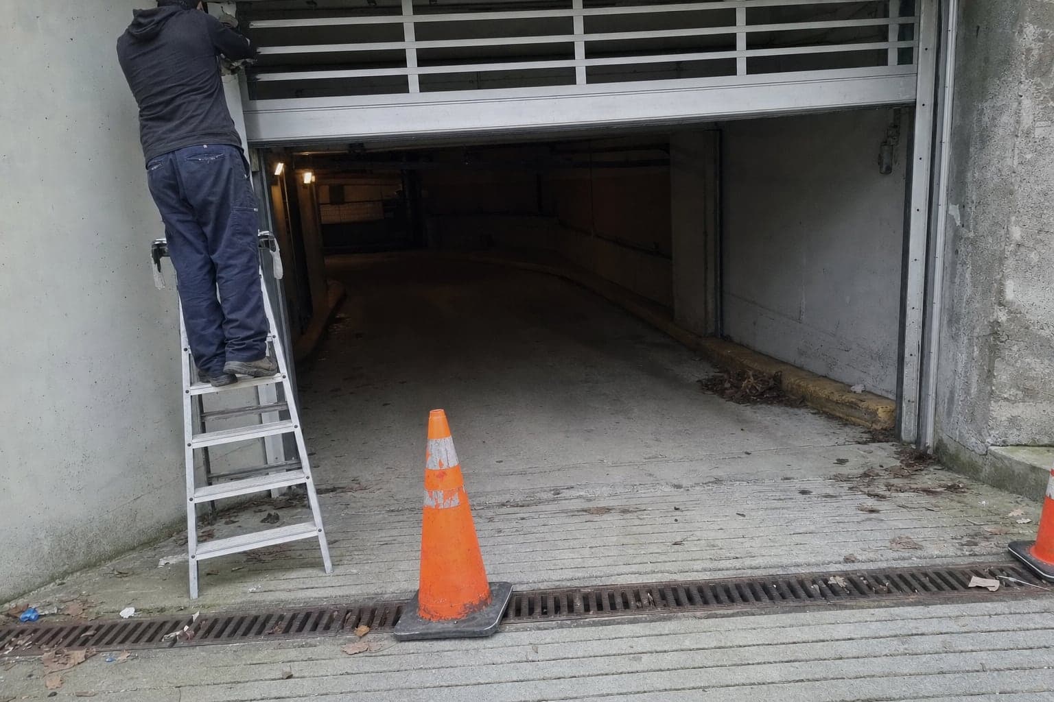 Servicing a parkade door at the entrance of a condo building