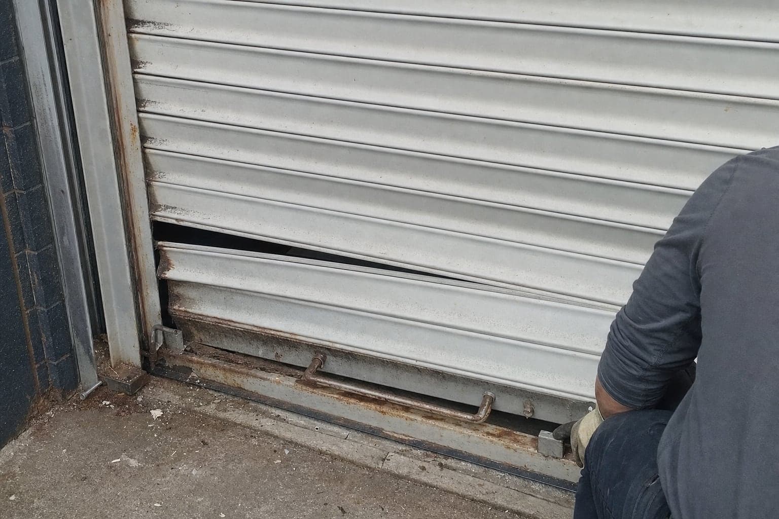 Bent slats on a rolling steel door